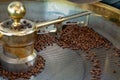 Traditional method of roasting dried organic arabica coffee beans in roster with open grid for cooling, bio coffee farm