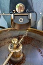 Traditional method of roasting dried organic arabica coffee beans in roster with open grid for cooling, bio coffee farm