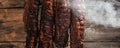 Traditional method of smoking meat in smoke. Smoked ham, bacon, pork neck and sausages in a smokehouse