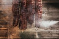 Traditional method of smoking meat in smoke. Smoked ham, bacon, pork neck and sausages in a smokehouse