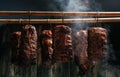 Traditional method of smoking meat in smoke. Smoked ham, bacon, pork neck and sausages in a smokehouse