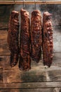 Traditional method of smoking meat in smoke. Smoked ham, bacon, pork neck and sausages in a smokehouse