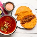 Mexican birria consomme and beef tacos on white background Royalty Free Stock Photo