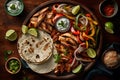 Traditional mexican chicken fajitas with vegetables and sauce on wooden background