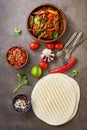 Traditional mexican cuisine , fajitas ,salsa sauce,tortilla on a dark rustic background. View from above, flat lay, copy space Royalty Free Stock Photo