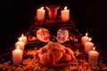 Mexican day of the dead altar with bread and sugar skulls on dark background Royalty Free Stock Photo