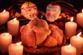Mexican day of the dead altar with bread and sugar skulls on dark background Royalty Free Stock Photo