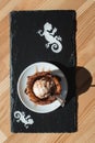 Traditional Mexican dessert churros served with ice cream on white plate on wooden table Royalty Free Stock Photo