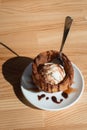 Traditional Mexican dessert churros served with ice cream on white plate on wooden table Royalty Free Stock Photo