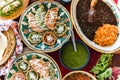 Traditional mexican dishes sopes, tacos dorados, tortillas, mole poblano, red rice, rajas poblanas, beans, pipian, salsa verde in Royalty Free Stock Photo