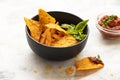Bowlof corn chips nachos with guacamole on marble kitchen table. Nachos chips snack. Traditional mexican food closeup on white