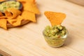 Traditional Mexican food. Eating nachos dip with guacamole sauce consist of avocado, tomato and cilantro Royalty Free Stock Photo