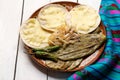 Mexican grilled nopal cactus with quesadillas and serrano chili peppers on white background