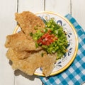 Mexican guacamole with pork chicharron on white background