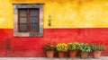 Traditional Mexican house with yellow and red walls and potted marigold flowers Royalty Free Stock Photo