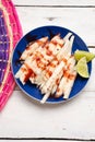 Mexican jicama cutted with chili powder and piquant sauce on white background