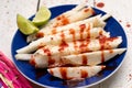 Mexican jicama cutted with chili powder and piquant sauce on white background