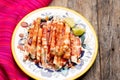 Mexican jicama  cutted with chili powder and piquant sauce on wooden background Royalty Free Stock Photo