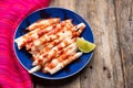 Mexican jicama  cutted with chili powder and piquant sauce on wooden background Royalty Free Stock Photo