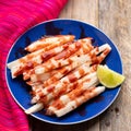 Mexican jicama  cutted with chili powder and piquant sauce on wooden background Royalty Free Stock Photo