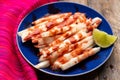 Mexican jicama  cutted with chili powder and piquant sauce on wooden background Royalty Free Stock Photo