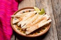 Mexican jicama cutted with chili powder on wooden background