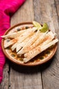 Mexican jicama cutted with chili powder on wooden background