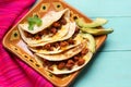 Mexican quesadillas with chorizo on turquoise background Royalty Free Stock Photo