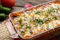 Mexican red baked enchiladas with melted cheese and sour cream on wooden background Royalty Free Stock Photo