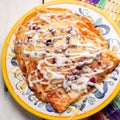 Mexican red enchiladas with melted cheese on white background Royalty Free Stock Photo