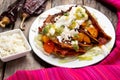 Mexican red enchiladas with potato and pork chorizo also called Potosinas on wooden background Royalty Free Stock Photo