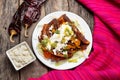 Mexican red enchiladas with potato and pork chorizo also called Potosinas on wooden background Royalty Free Stock Photo