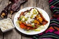 Mexican red enchiladas with potato and pork chorizo also called Potosinas on wooden background Royalty Free Stock Photo