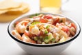 Mexican shrimp ceviche with tomato and serrano pepper on white background Royalty Free Stock Photo