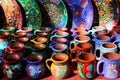 Traditional Mexican souvenirs. Multi-colored ceramic mugs and tableware in the gift shop. Selective focus. Royalty Free Stock Photo