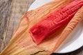 Mexican sweet tamales with strawberry jam on wooden background