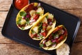 Traditional Mexican tacos al pastor with pork, pineapple, onions and herbs close-up on a plate. horizontal top view Royalty Free Stock Photo