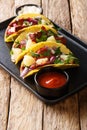 Traditional Mexican tacos al pastor with pork, pineapple, onions and herbs close-up on a plate. vertical Royalty Free Stock Photo