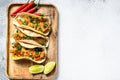 Traditional Mexican tacos with parsley, cheese and chili peppers. White background. Top view. Copy space Royalty Free Stock Photo