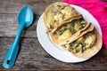 Mexican tacos of poblano rajas with potatoes and sour cream on wooden background