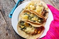 Mexican tacos of poblano rajas with potatoes and sour cream on wooden background Royalty Free Stock Photo