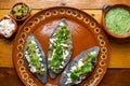 Mexican tlacoyos with green sauce