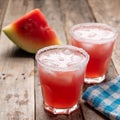 Mexican watermelon margarita cocktail on wooden background