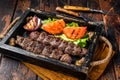 Traditional middle east kefta or kofta kebab, ground beef and lamb meat grilled on skewers served with tomato, salad and