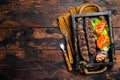 Traditional middle east kefta or kofta kebab, ground beef and lamb meat grilled on skewers served with tomato, salad and