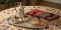Traditional Middle Eastern coffee set with nuts and sweets on decorative table Royalty Free Stock Photo
