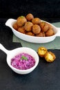 Traditional Middle Eastern food, Falafel (tamiya) with red cabbage salad with vegan mayonnaise on black wooden background and
