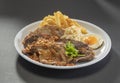 Traditional mixed grill platter Grilled Lamb Chop, chicken cutlet, chicken chop, french fries, eggs and salad in white dish on