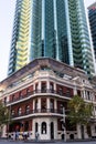 Traditional and modern buildings at the city. Colonial house at a corner in front of offices tower made of glass material. Perth, Royalty Free Stock Photo