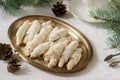 Traditional Moldavian shortcake cookies with jam stuffing and a cup of tea on the background of winter decor.